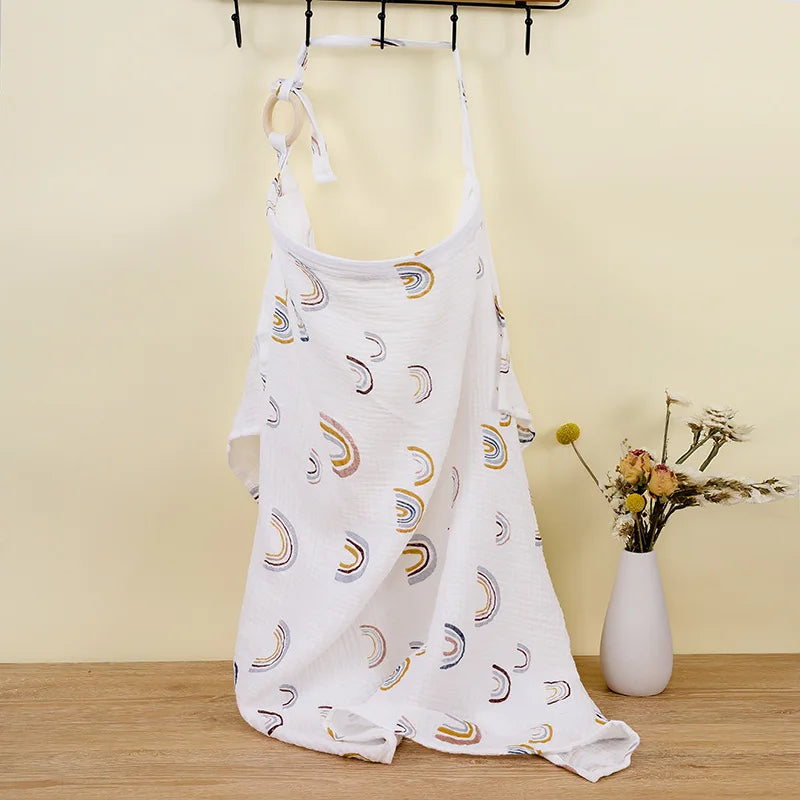 White dress with moon pattern hanging on a rack against a yellow wall.