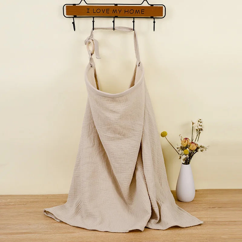 Beige apron on a mannequin with 'I LOVE MY HOME' sign in the background