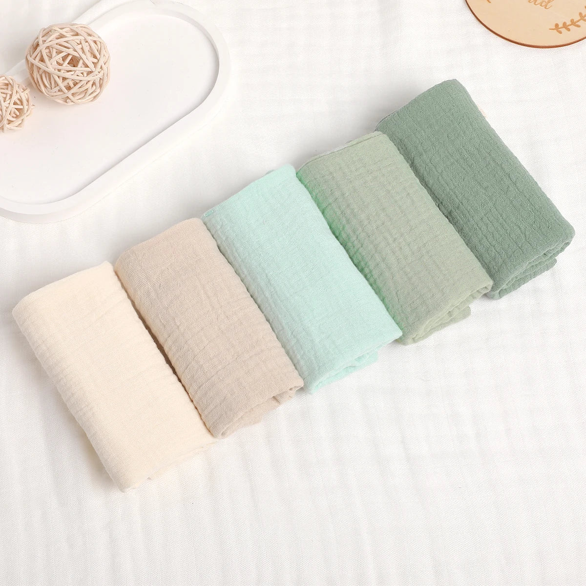 1. “Stack of 6-layer organic cotton baby washcloths in neutral colors”
2. “Soft and absorbent eco-friendly baby washcloths set”
3. “Close-up of breathable 100% cotton fabric texture”
4. “Baby towel used as a burp cloth on a newborn’s shoulder”
5. “Folded pure cotton baby wipes laid on a clean surface”