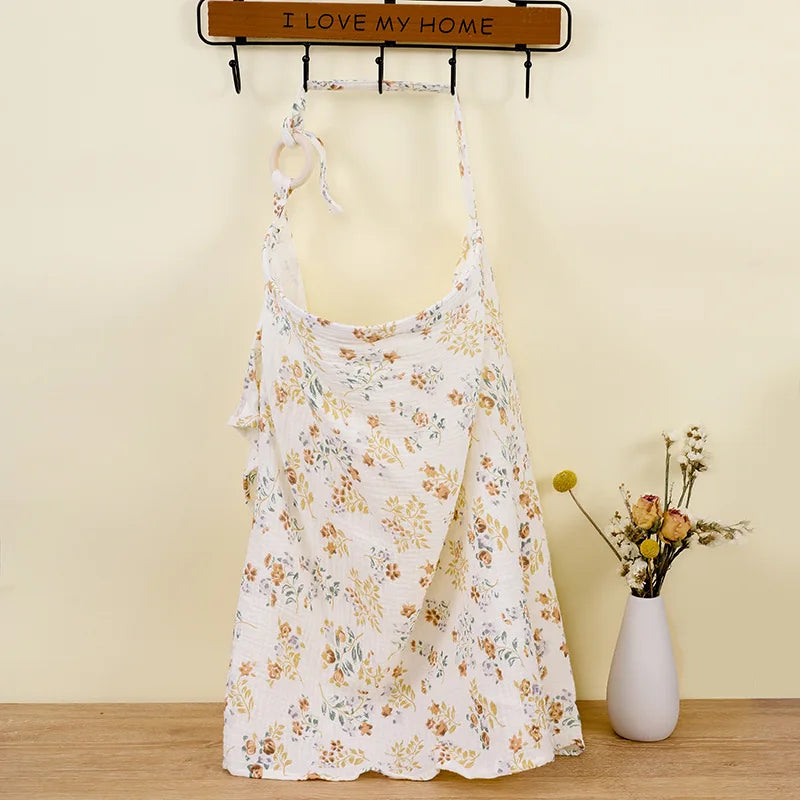 Floral dress on a mannequin against a yellow wall with a vase of flowers.