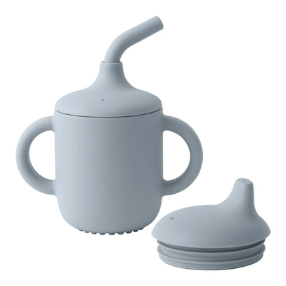 Light blue sippy cup with straw and additional lid on a white background