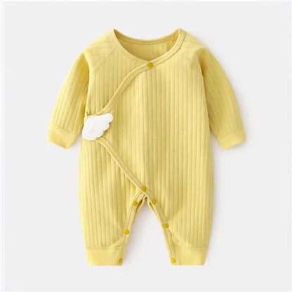Yellow baby romper with cloud design on a white background