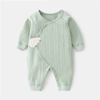 Light green baby romper with angel wings on a white background
