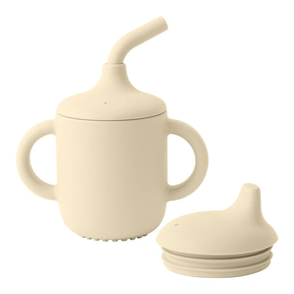 Beige silicone sippy cup with additional lid on a white background