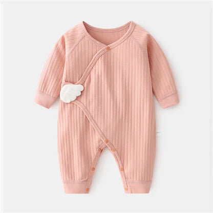 Pink baby romper with cloud design on a white background
