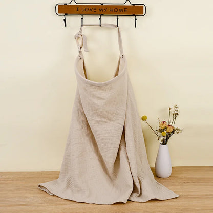 Beige apron on a mannequin with 'I LOVE MY HOME' sign in the background