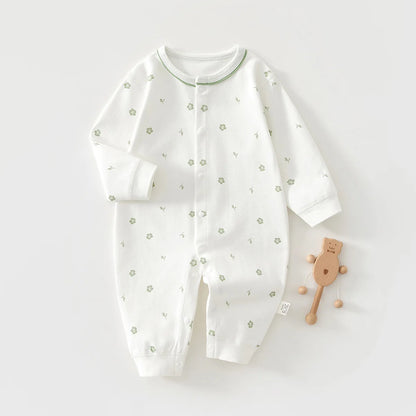 White baby onesie with green floral patterns on a white background