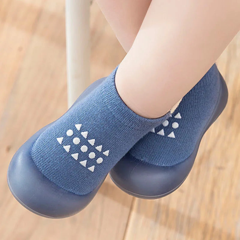 Blue socks with white patterns on a wooden floor